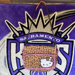 Sanrio Hello Kitty messenger bag with a leopard print pattern and pink trim